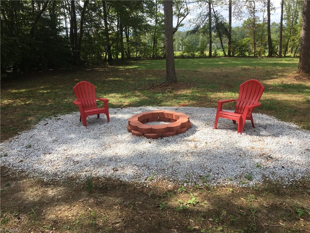 2084 Red Brush Road Mount Airy, NC 27030 - Photo 18 of 19 Fire pit overlooking large backyard and tobacco field.