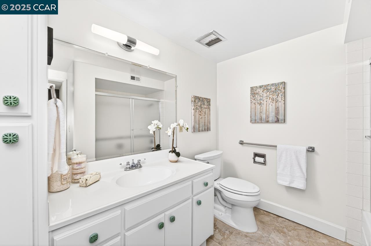 1400 Ptarmigan Drive, Unit 2 Walnut Creek, CA 94595 - Photo 19 of 44 a bathroom with a toilet sink and mirror
