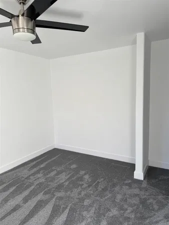 a bathroom with a granite countertop toilet and a sink