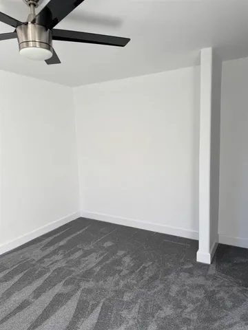 a bathroom with a granite countertop toilet and a sink
