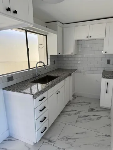 a view of bathroom with a sink and a mirror