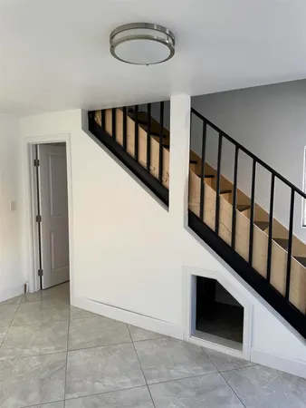 a view of staircase with white walls and a window