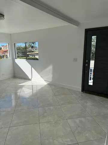 a view of an entryway with wooden floor