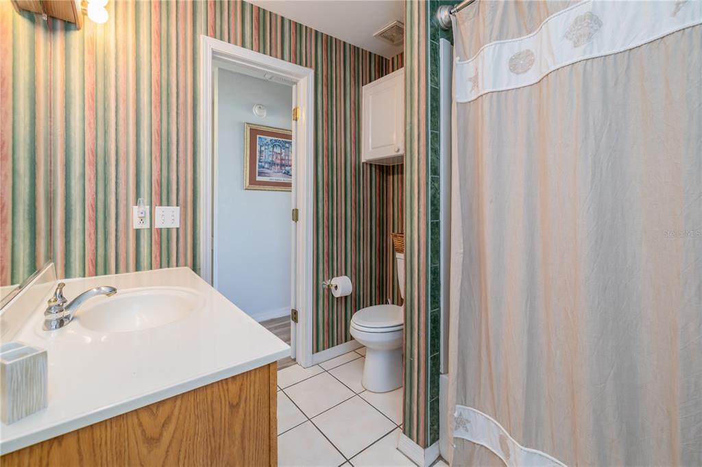4786 South Atlantic Avenue, Unit 4B Ponce Inlet, FL 32127 - Photo 18 of 22 a bathroom with a sink a toilet and shower