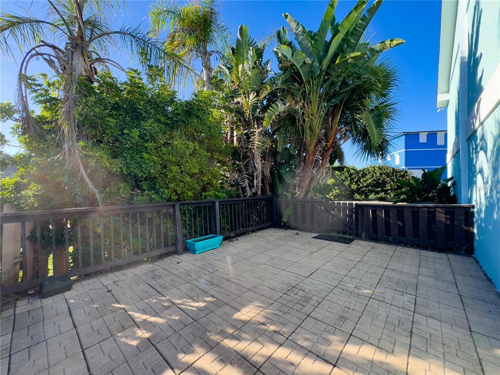 4786 South Atlantic Avenue, Unit 4B Ponce Inlet, FL 32127 - Photo 20 of 22 a view of backyard with potted plants and wooden fence