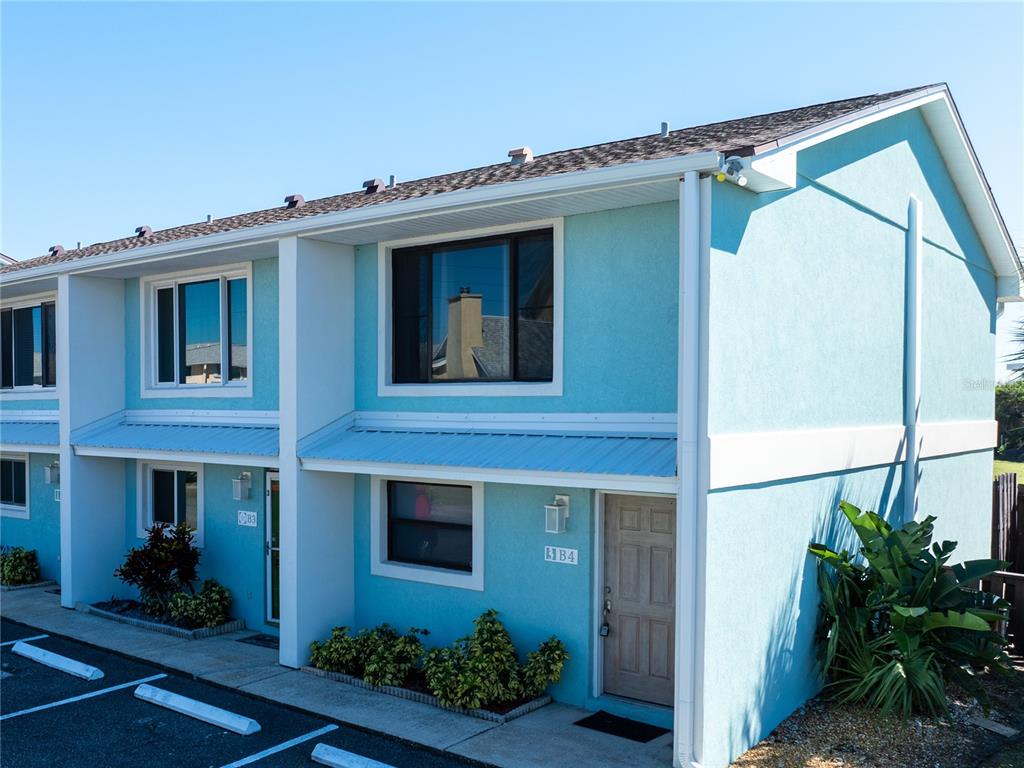 4786 South Atlantic Avenue, Unit 4B Ponce Inlet, FL 32127 - Photo 2 of 22 a front view of a house with plants