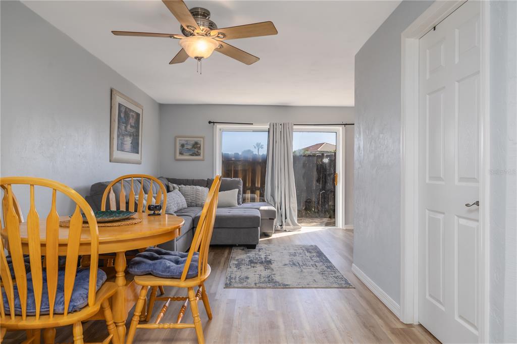 4786 South Atlantic Avenue, Unit 4B Ponce Inlet, FL 32127 - Photo 5 of 22 a view of a dining room with furniture wooden floor and a chandelier fan