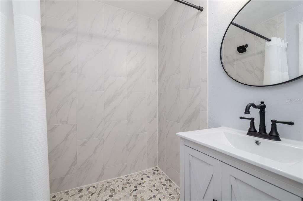 4786 South Atlantic Avenue, Unit 4B Ponce Inlet, FL 32127 - Photo 9 of 22 a bathroom with a sink and a mirror