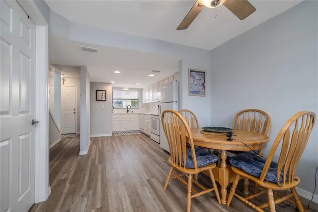 a view of a dining room with furniture and wooden floor