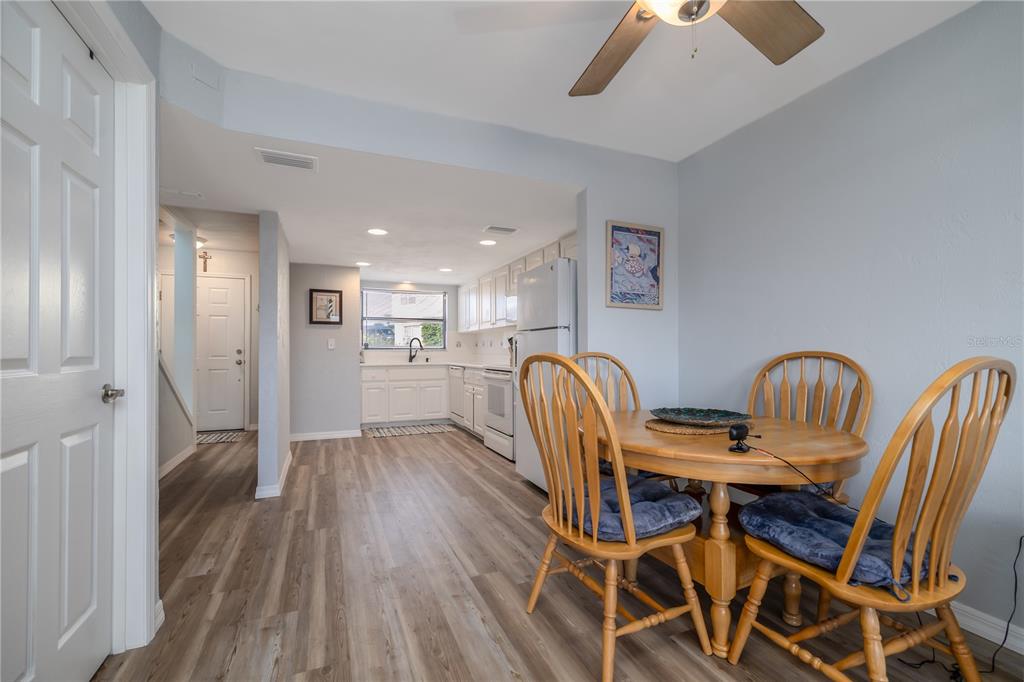 4786 South Atlantic Avenue, Unit 4B Ponce Inlet, FL 32127 - Photo 10 of 22 a view of a dining room with furniture and wooden floor