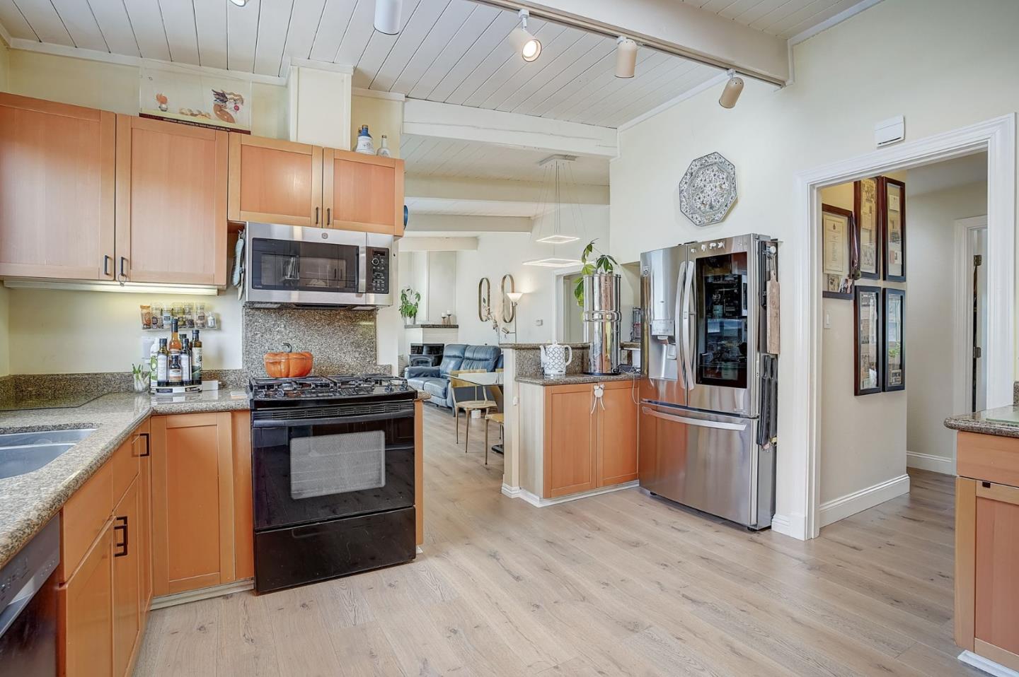 274 Hillside Drive Pacifica, CA 94044 - Photo 11 of 56 a kitchen with stainless steel appliances granite countertop a stove a sink dishwasher and a refrigerator with wooden floor