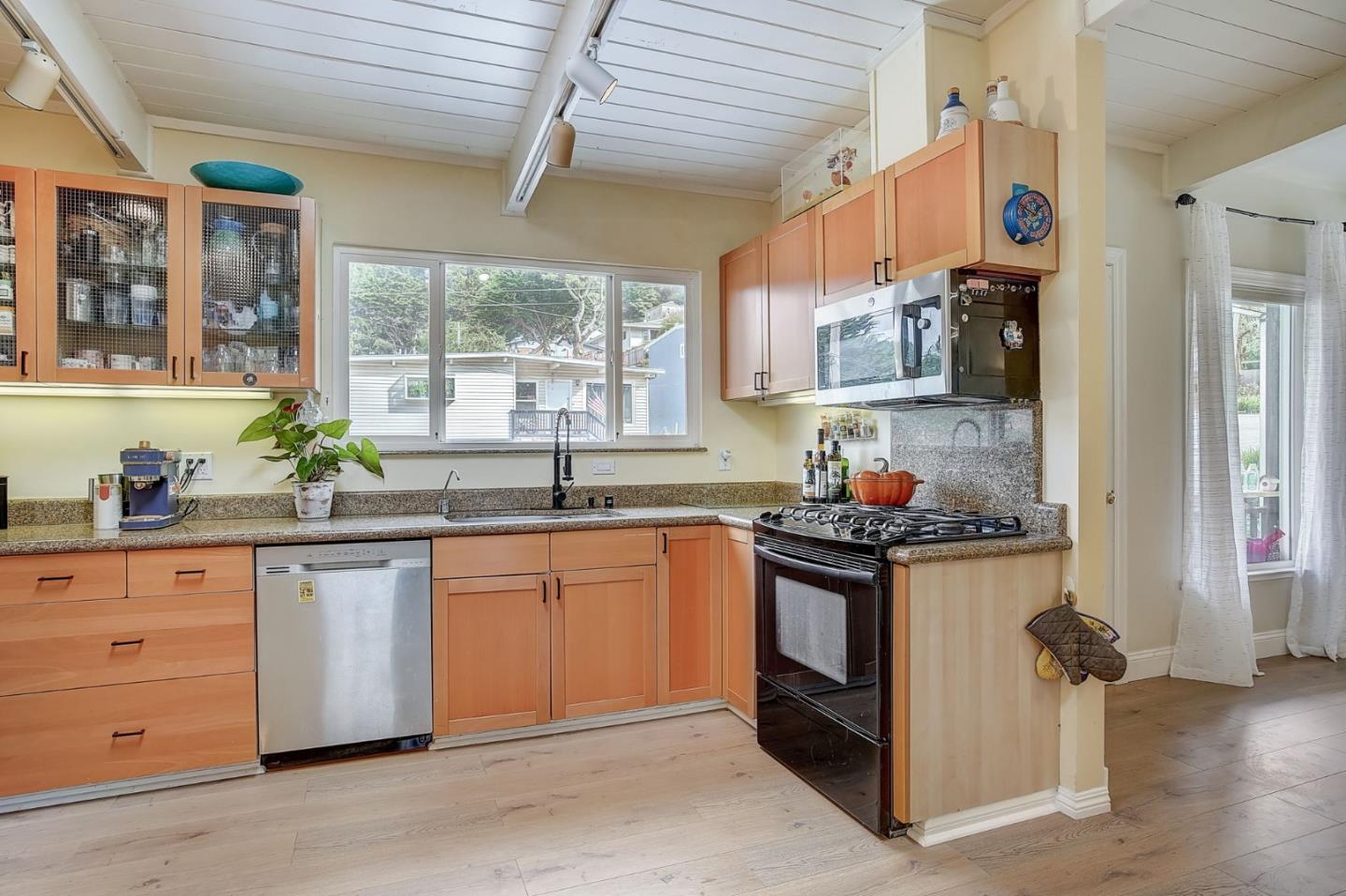 274 Hillside Drive Pacifica, CA 94044 - Photo 12 of 56 a kitchen with stainless steel appliances granite countertop a stove and a sink