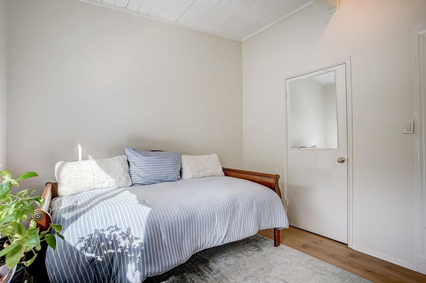 274 Hillside Drive Pacifica, CA 94044 - Photo 16 of 56 a bedroom with a bed and a potted plant