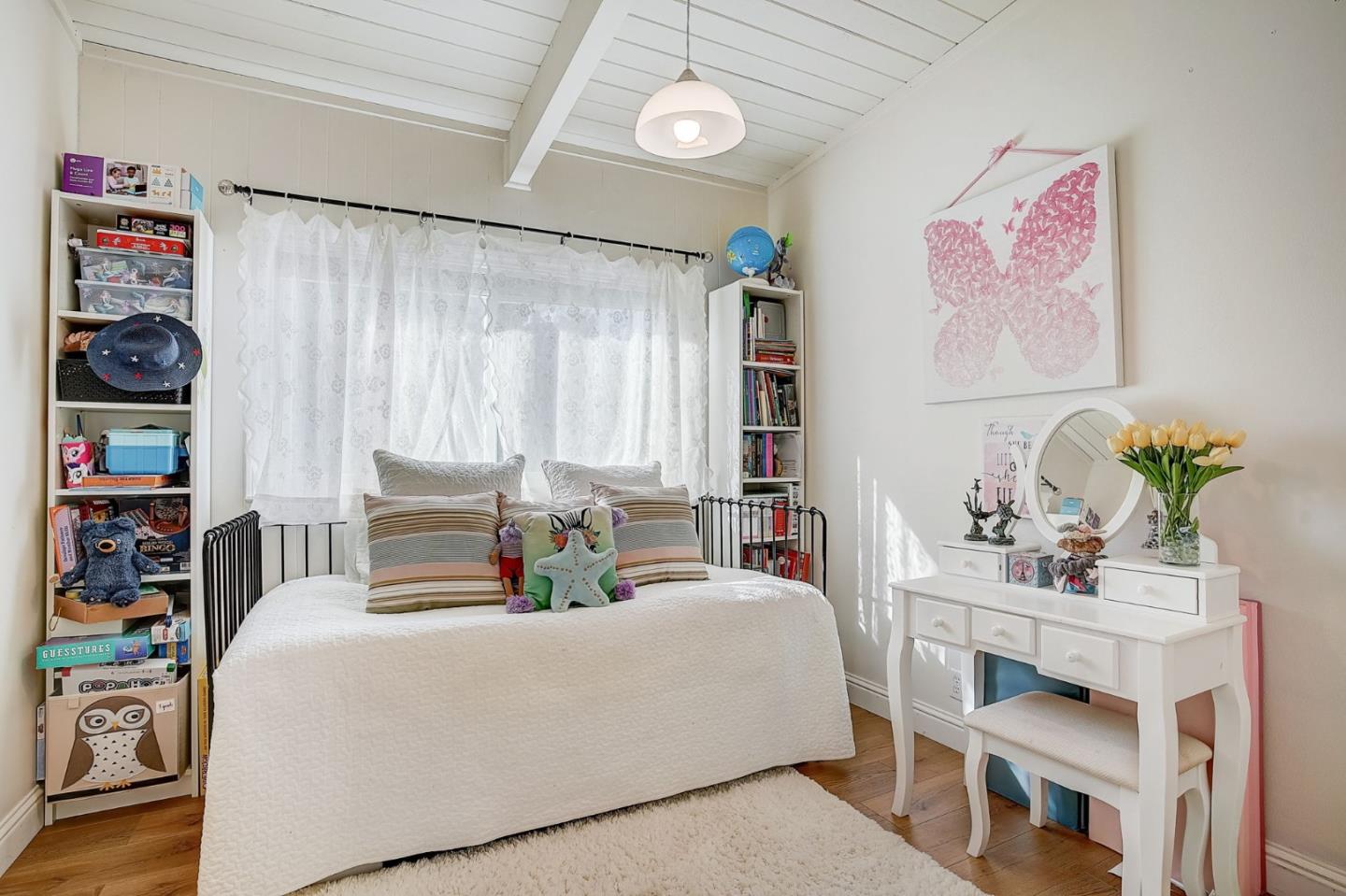 274 Hillside Drive Pacifica, CA 94044 - Photo 17 of 56 a bedroom with a bed and a table in it