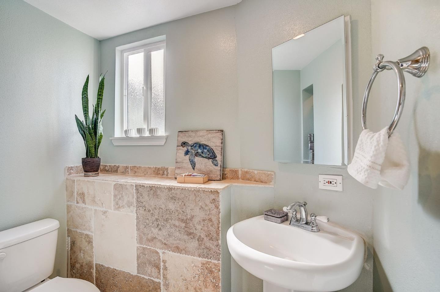 274 Hillside Drive Pacifica, CA 94044 - Photo 27 of 56 a bathroom with a sink and a mirror