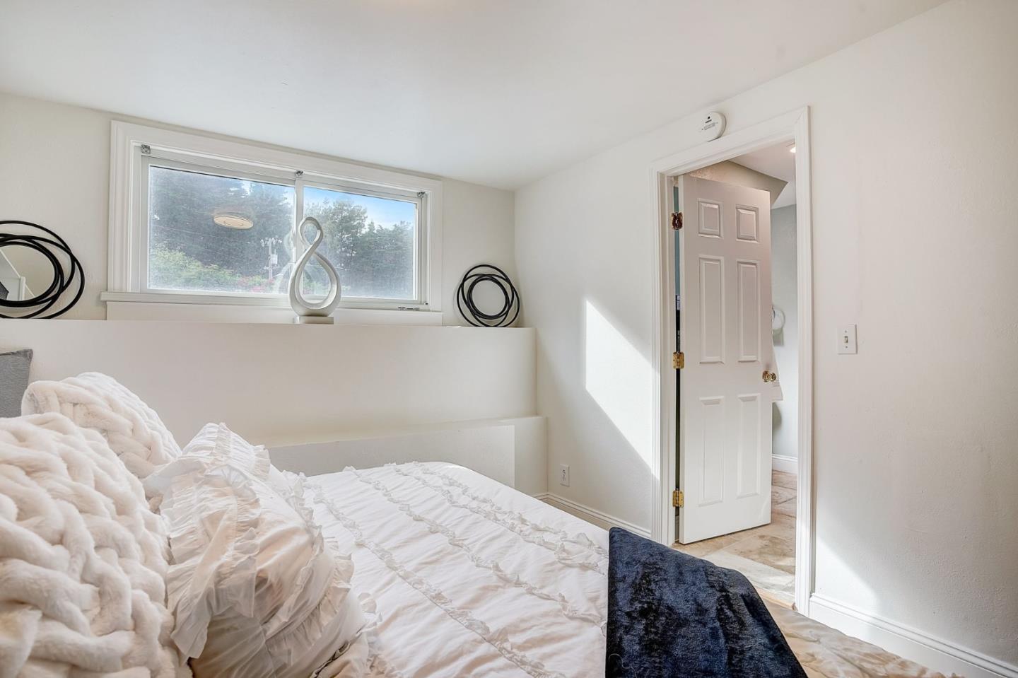 274 Hillside Drive Pacifica, CA 94044 - Photo 30 of 56 a bedroom with a bed and a window