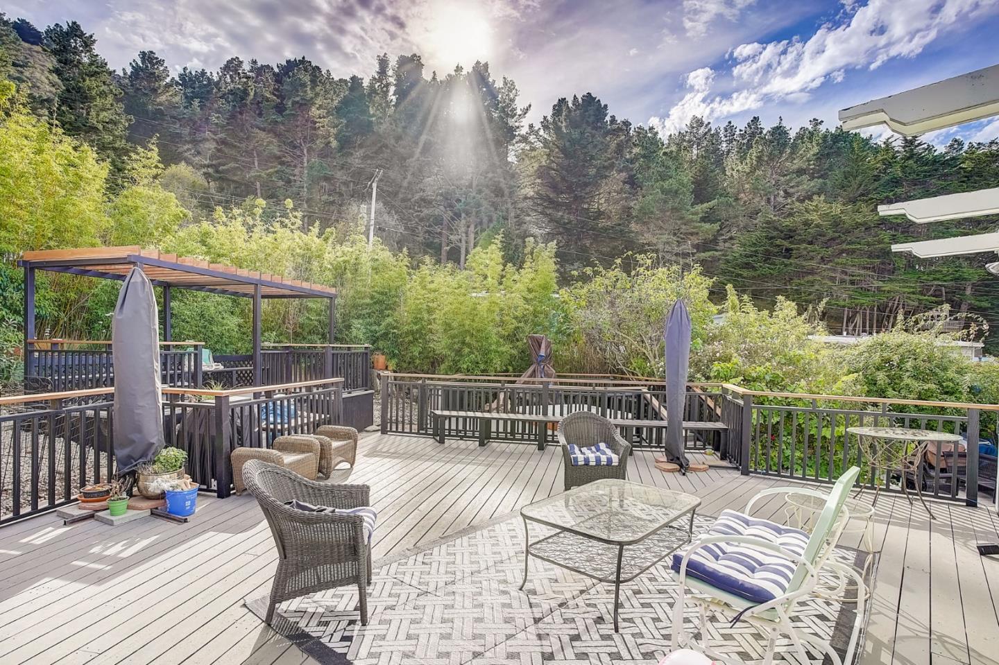 274 Hillside Drive Pacifica, CA 94044 - Photo 36 of 56 a view of a patio with a dining table and chairs with wooden floor