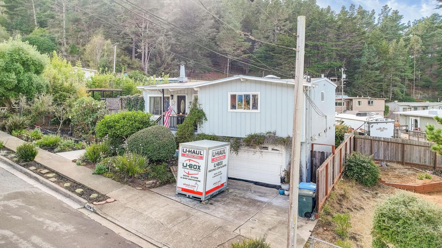 274 Hillside Drive Pacifica, CA 94044 - Photo 44 of 56 a backyard of a house with a tree and outdoor seating