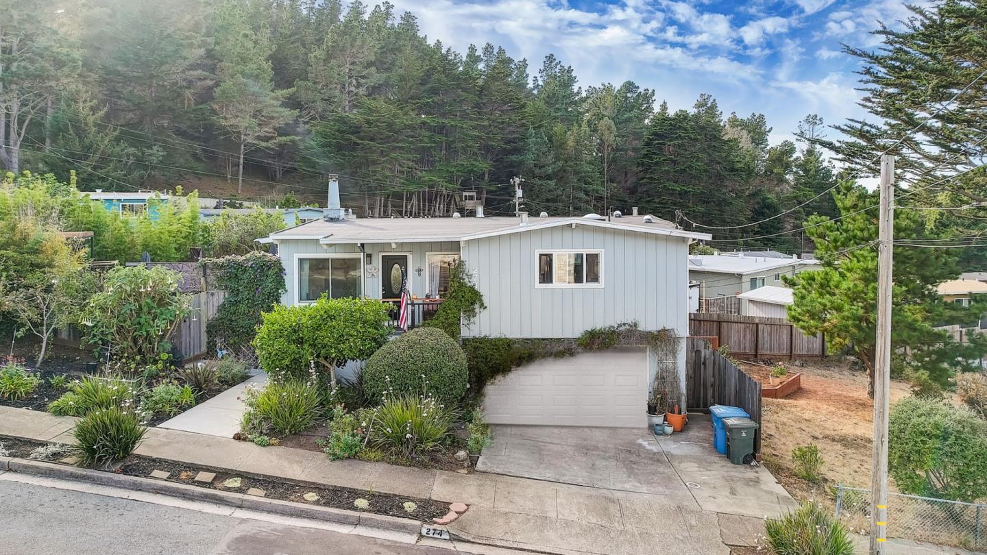 274 Hillside Drive Pacifica, CA 94044 - Photo 5 of 56 a front view of a house with a garden