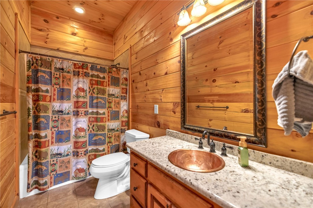 7994 3 Top Road Todd, NC 28684 - Photo 23 of 50 a bathroom with a granite countertop toilet sink and mirror