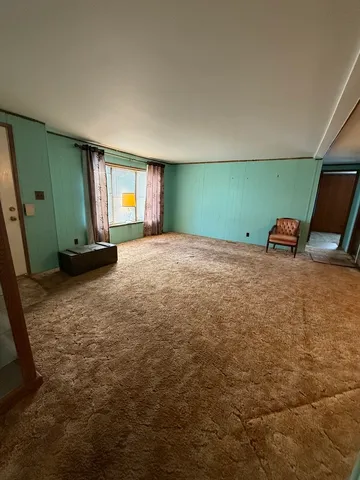 a view of a room with gym equipment and windows