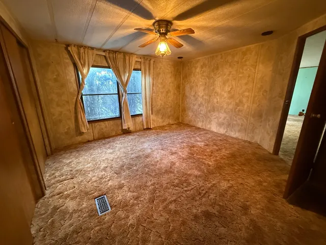 a view of empty room with a fireplace