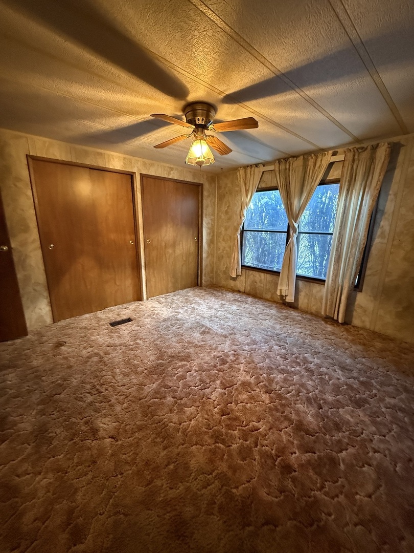 278 Blackthorn Road Matteson, IL 60443 - Photo 14 of 20 a view of a room with a ceiling fan and a window