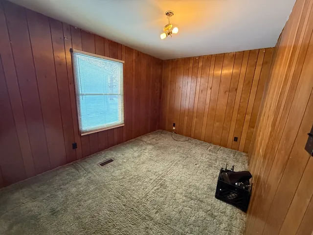 a view of an empty room and a window