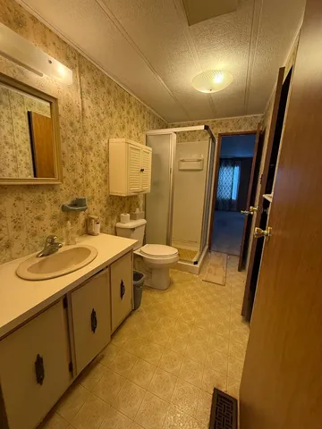 a bathroom with a sink and mirror with toilet