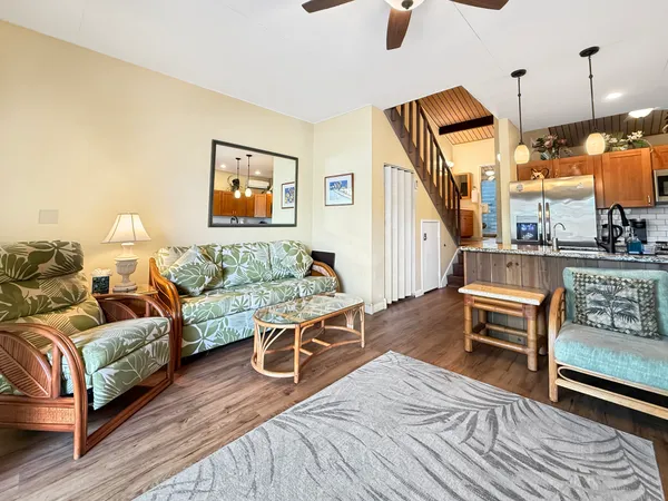 a living room with furniture and a wooden floor