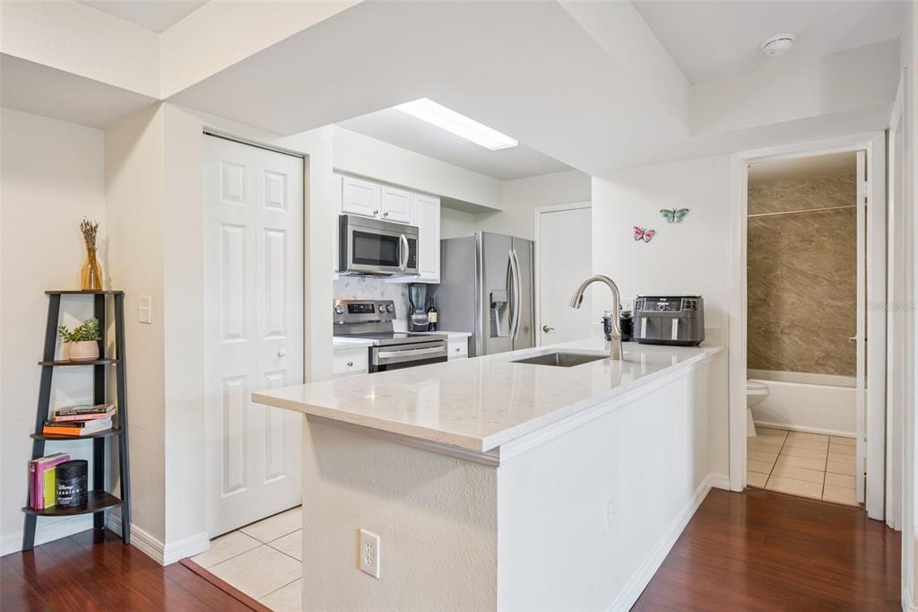 3032 Parkway Boulevard, Unit 305 Kissimmee, FL 34747 - Photo 7 of 40 a kitchen with kitchen island a sink appliances and cabinets