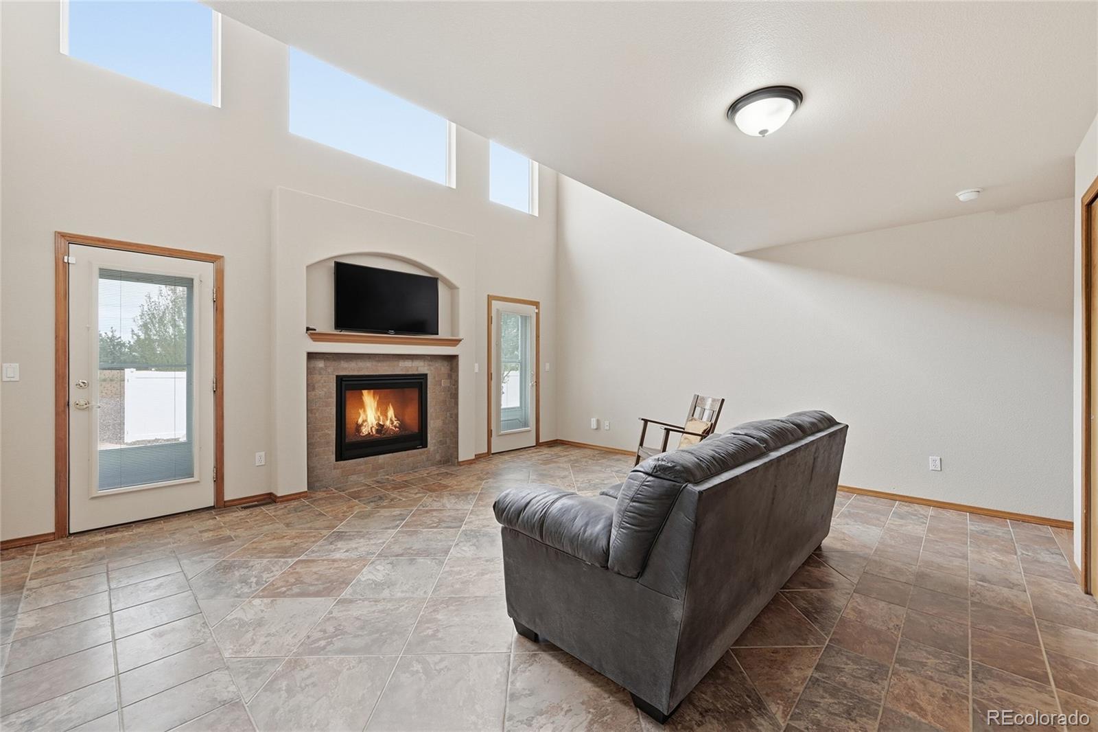9288 Rockingham Drive Peyton, CO 80831 - Photo 8 of 49 a living room with furniture and a fireplace
