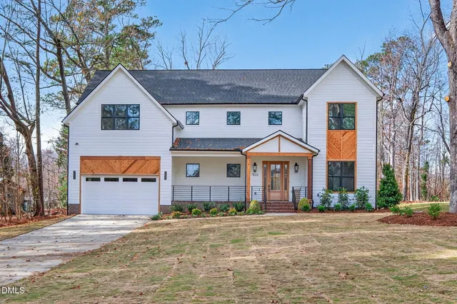 a front view of a house with a yard and garage