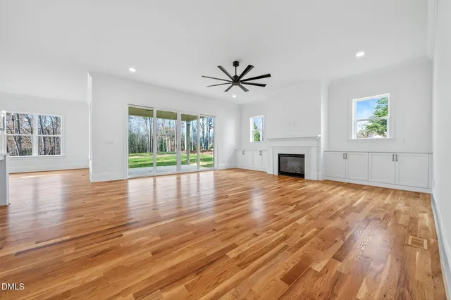 an empty room with a window and fireplace