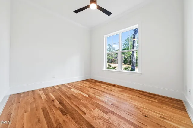 a view of bedroom with wooden floor and closet