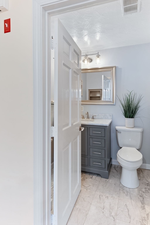 17 Weaver Street Wareham, MA 02576 - Photo 15 of 37 a bathroom with a toilet sink and mirror