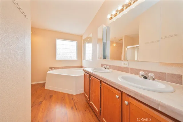 a bathroom with a sink double vanity and a bathtub