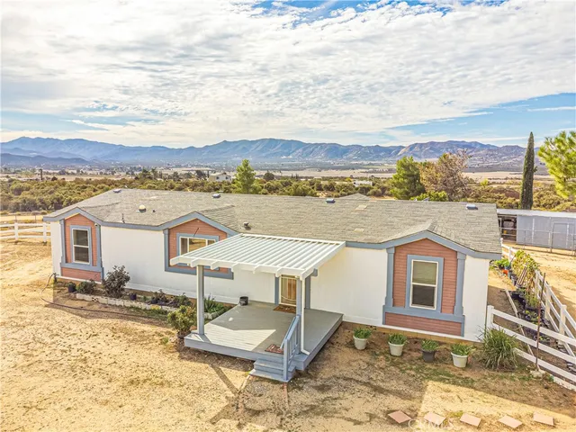 an aerial view of a house with a floor to ceiling window yard and ocean view