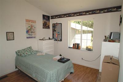 2701 Muir Mill Road Willits, CA 95490 - Photo 8 of 11 a bedroom with a bed and wooden floor