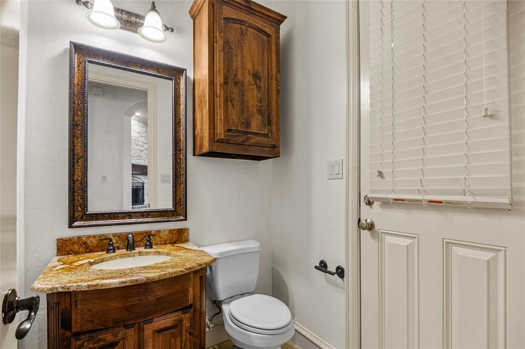 961 Deer Run Prosper, TX 75078 - Photo 17 of 34 a bathroom with a toilet a sink and mirror