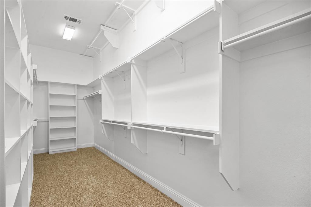 961 Deer Run Prosper, TX 75078 - Photo 20 of 34 a view of walk in closet with empty racks