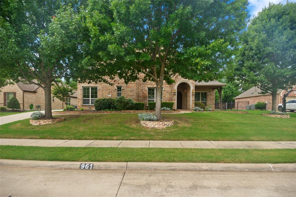 961 Deer Run Prosper, TX 75078 - Photo 2 of 34 a front view of a house with a yard