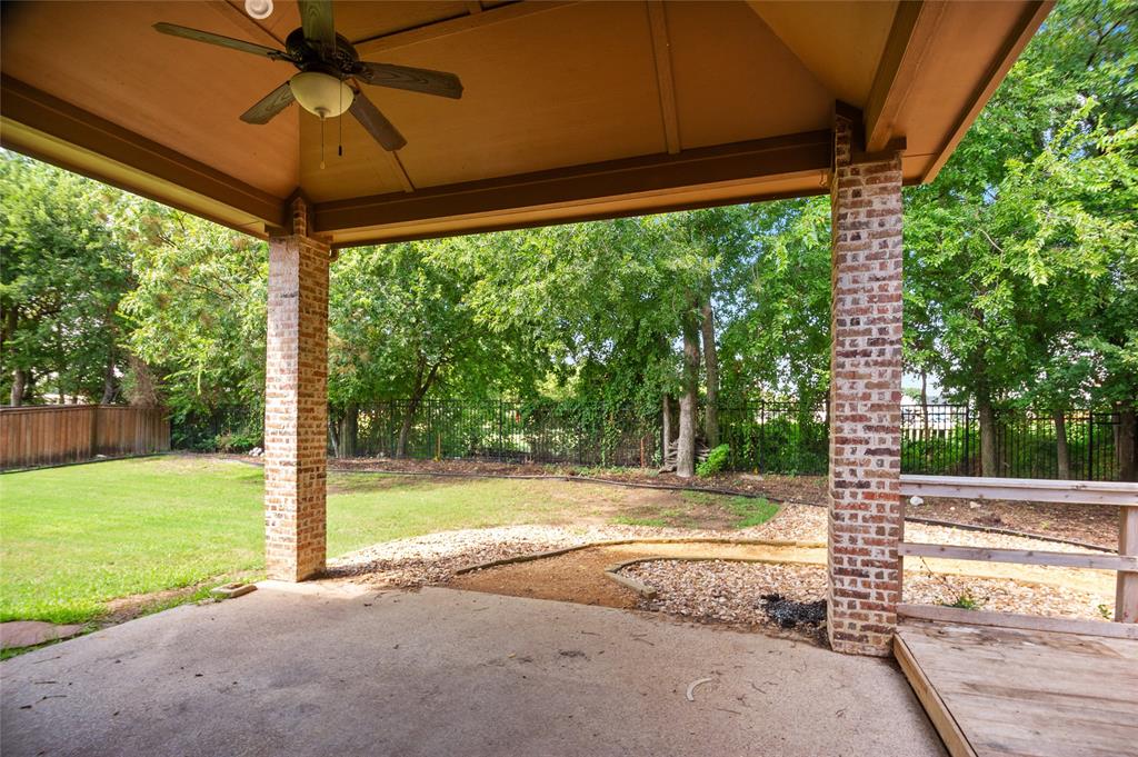961 Deer Run Prosper, TX 75078 - Photo 27 of 34 a view of a patio with a table and chairs under an umbrella