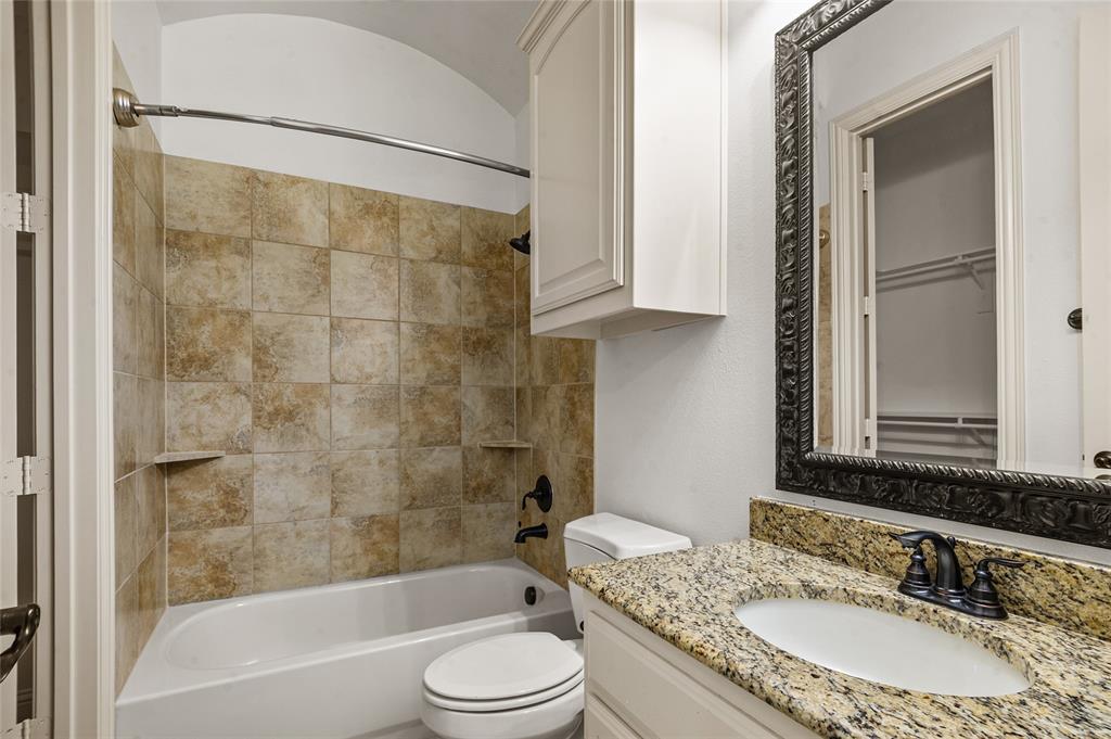 961 Deer Run Prosper, TX 75078 - Photo 7 of 34 a bathroom with a granite countertop bathtub shower sink vanity and toilet
