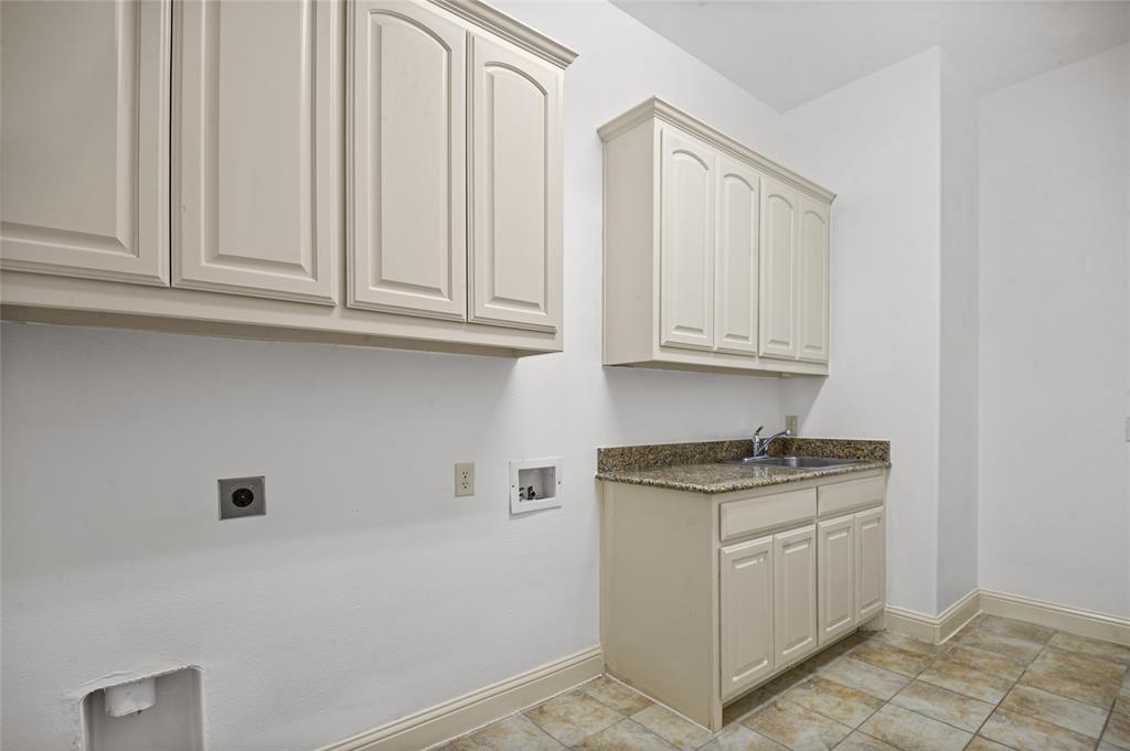 961 Deer Run Prosper, TX 75078 - Photo 8 of 34 a kitchen with white cabinets and sink