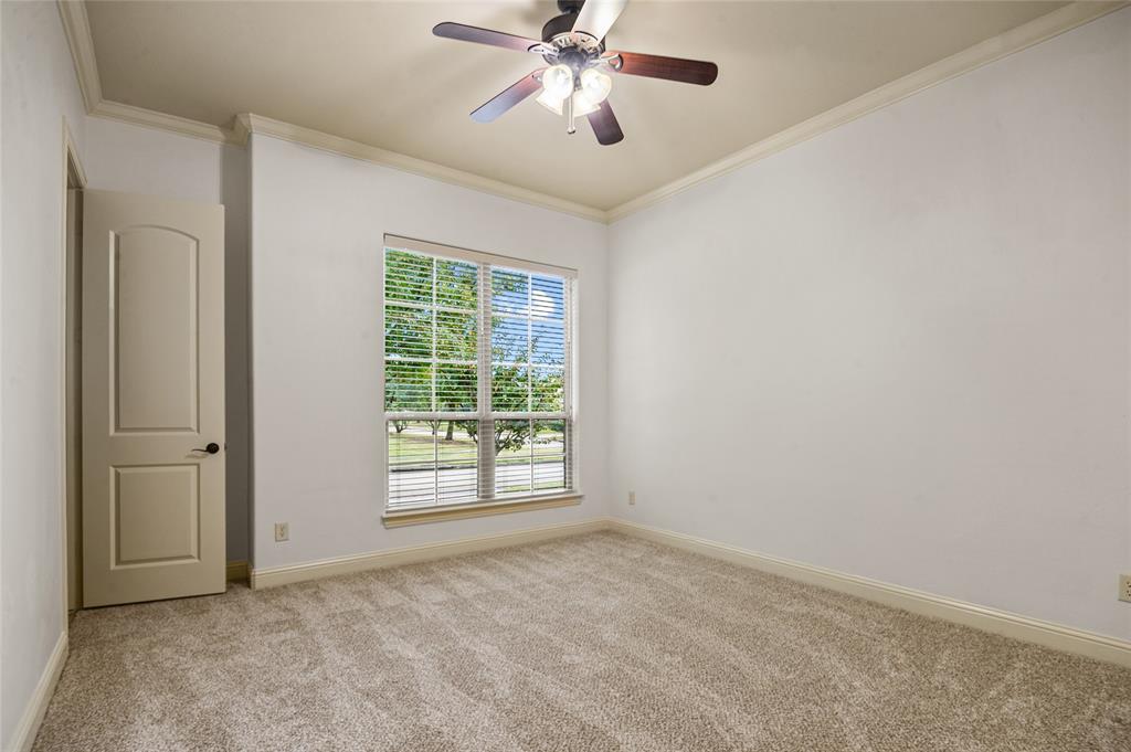 961 Deer Run Prosper, TX 75078 - Photo 9 of 34 an empty room with windows and fan