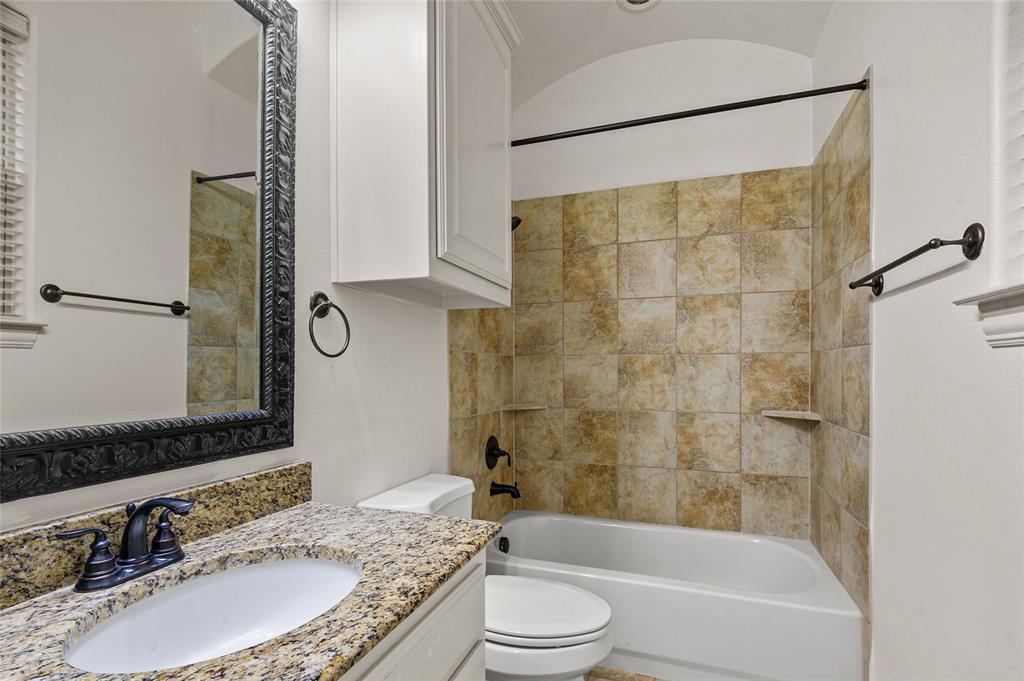 961 Deer Run Prosper, TX 75078 - Photo 10 of 34 a bathroom with a granite countertop sink toilet and shower