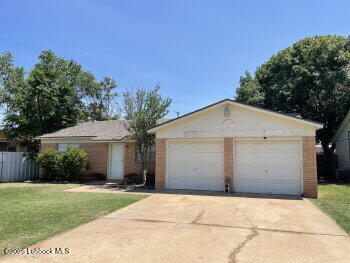 5309 22nd Street Lubbock, TX 79407 - Photo 2 of 13 a front view of a house with a garden and trees