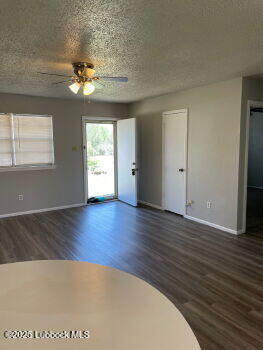 5309 22nd Street Lubbock, TX 79407 - Photo 4 of 13 a view of an empty room with wooden floor and fan
