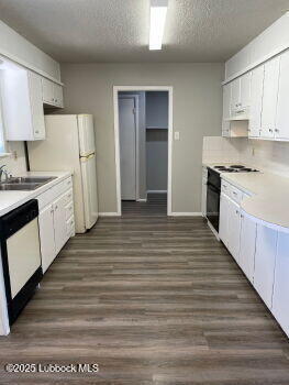 5309 22nd Street Lubbock, TX 79407 - Photo 5 of 13 a large kitchen with granite countertop a stove a sink dishwasher and a refrigerator